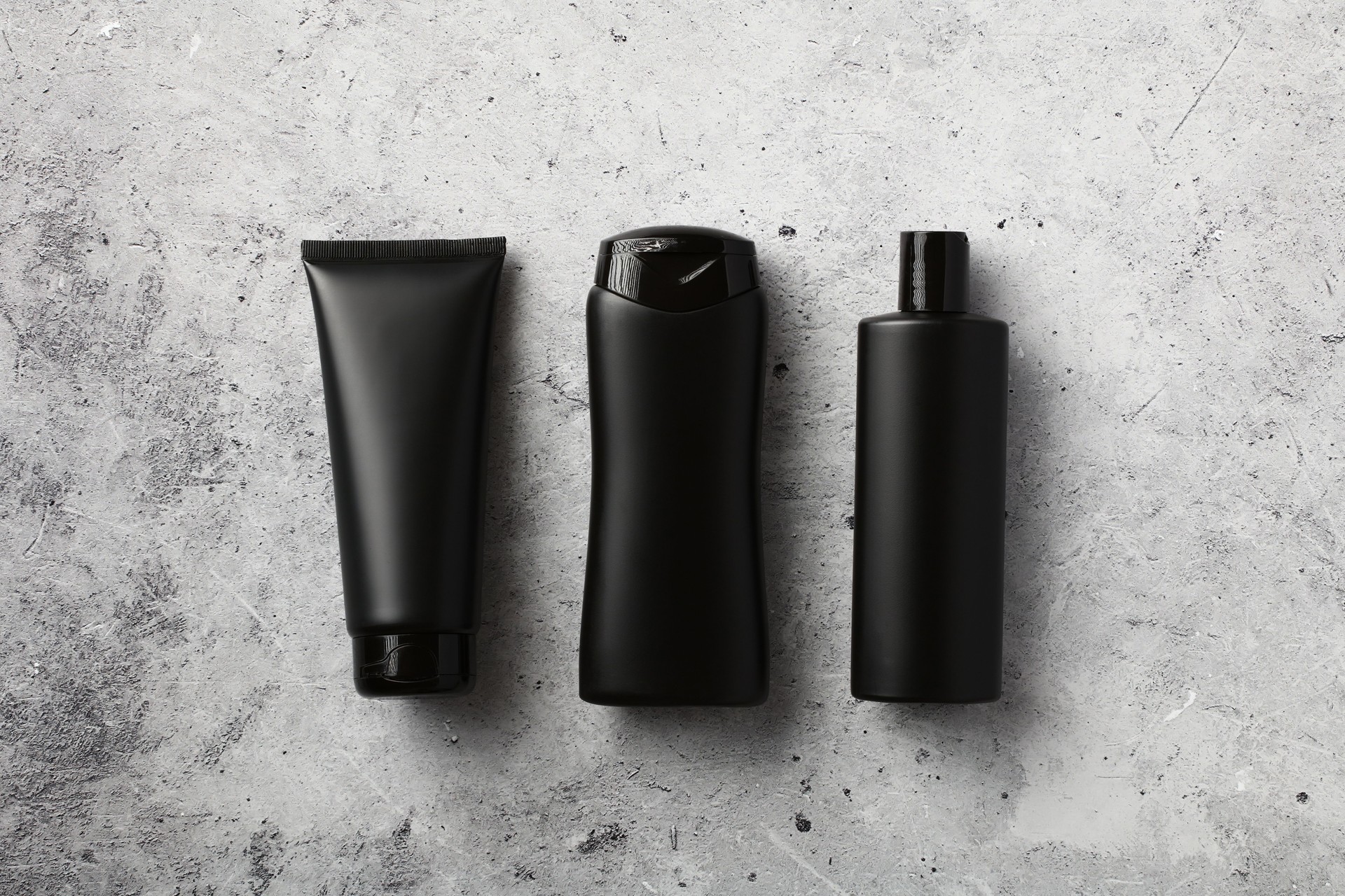Flat lay composition with men's cosmetic products for hair care on concrete background