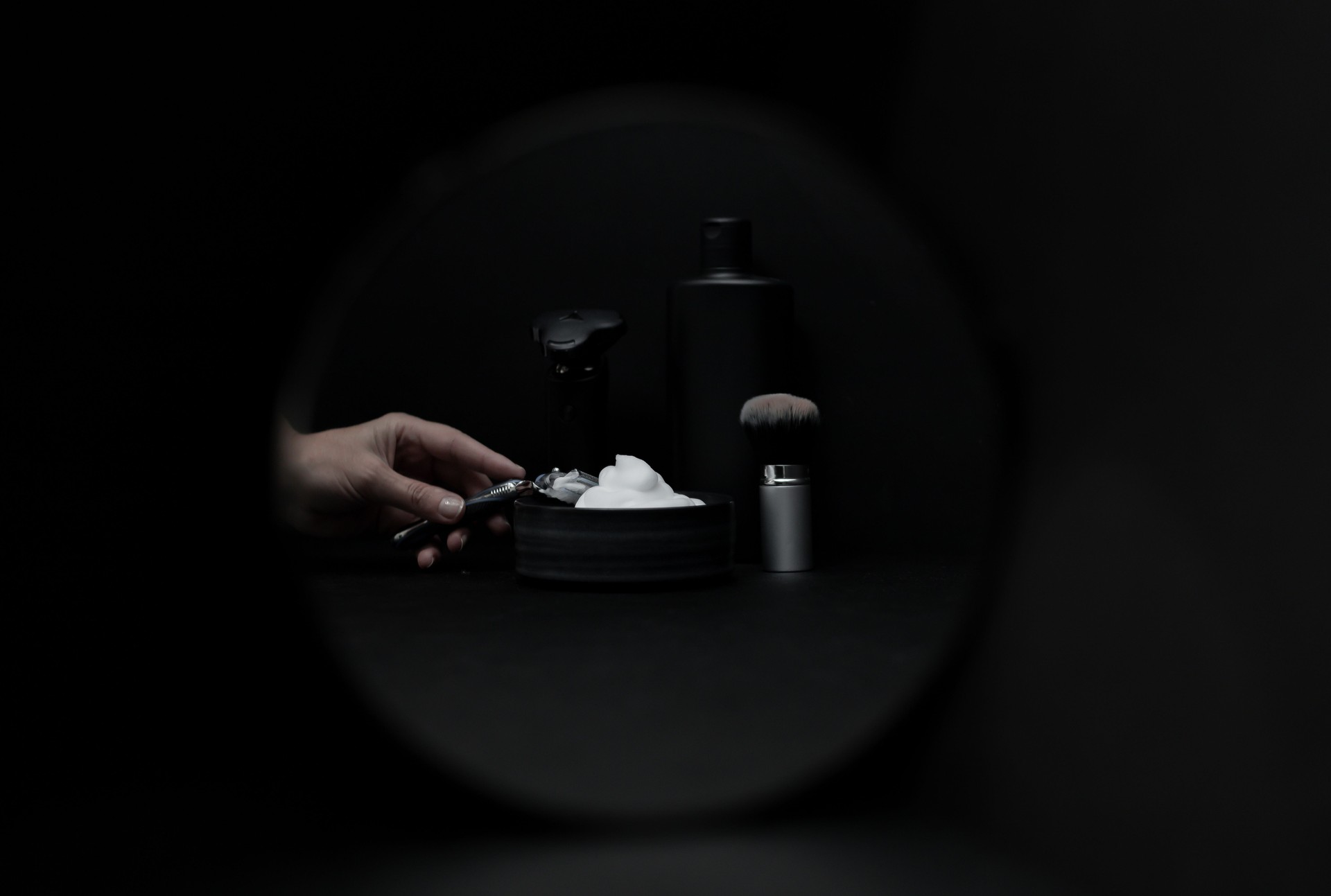 A set of items for shaving a beard on a black background.